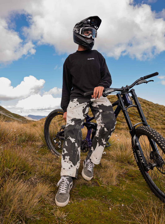 Person with a mountain bike in a mountainous landscape