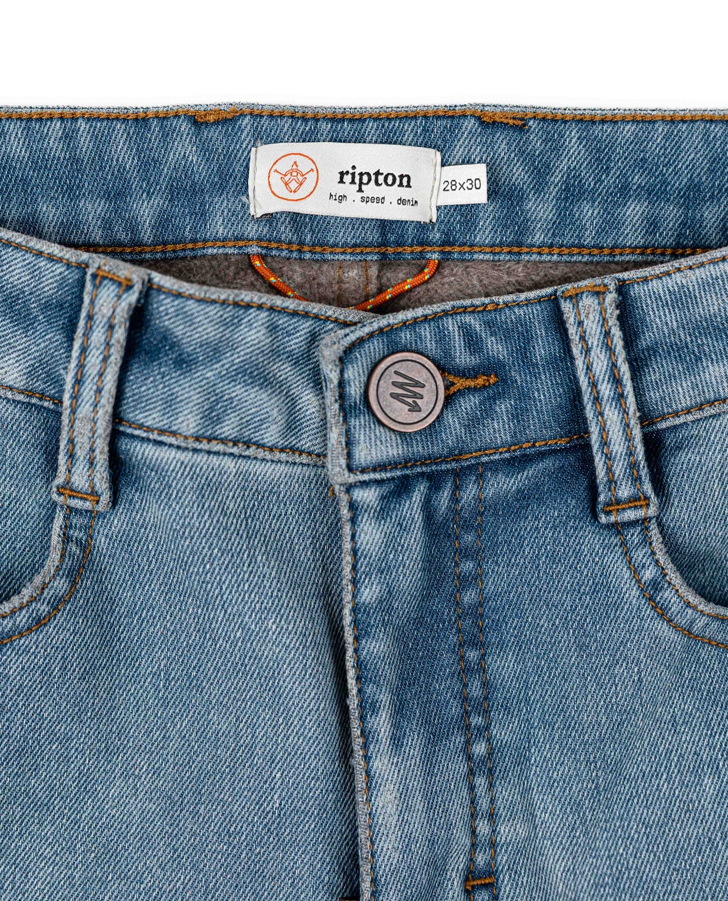 Close-up of blue jeans with a visible brand label on a white background