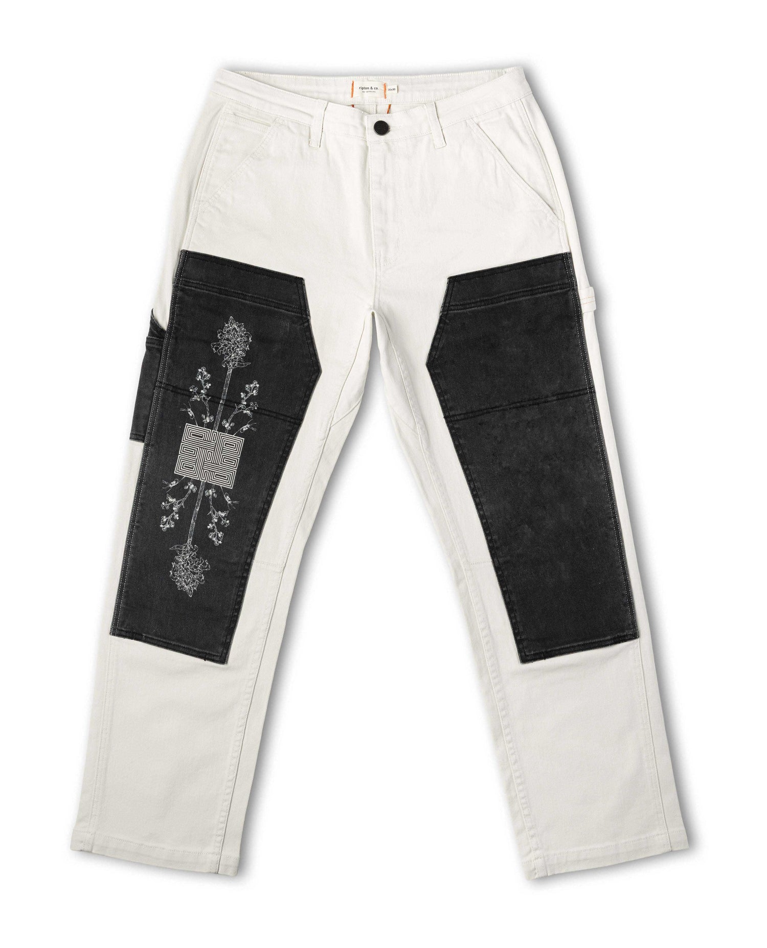 White pants with black patchwork design on a white background