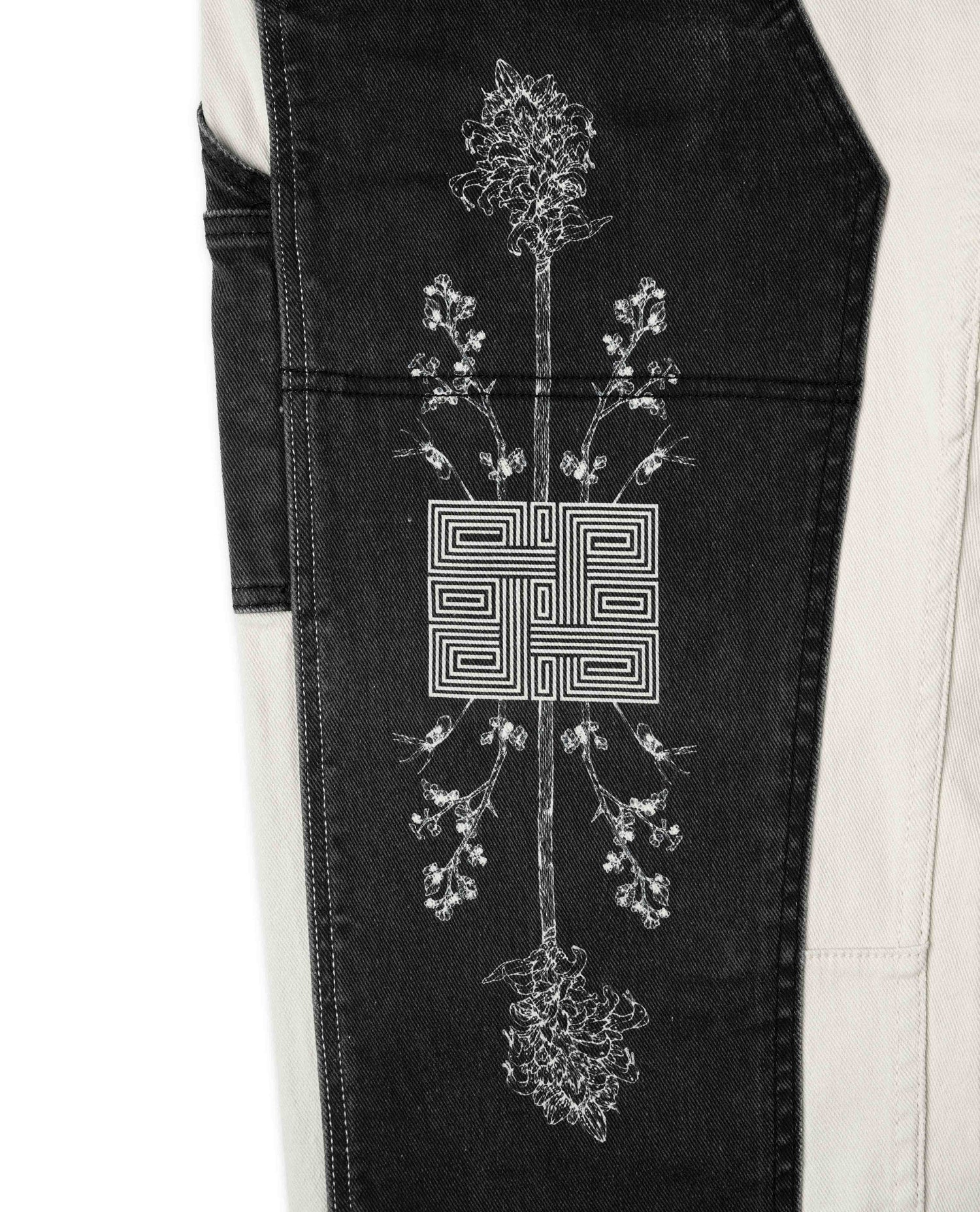 Black apron with white floral embroidery on a white background