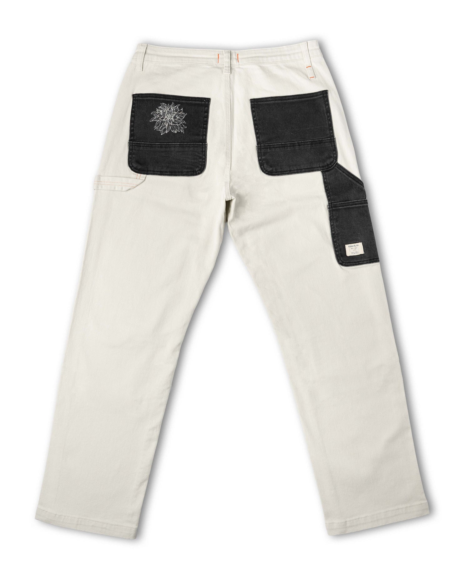 White pants with black patches on a white background