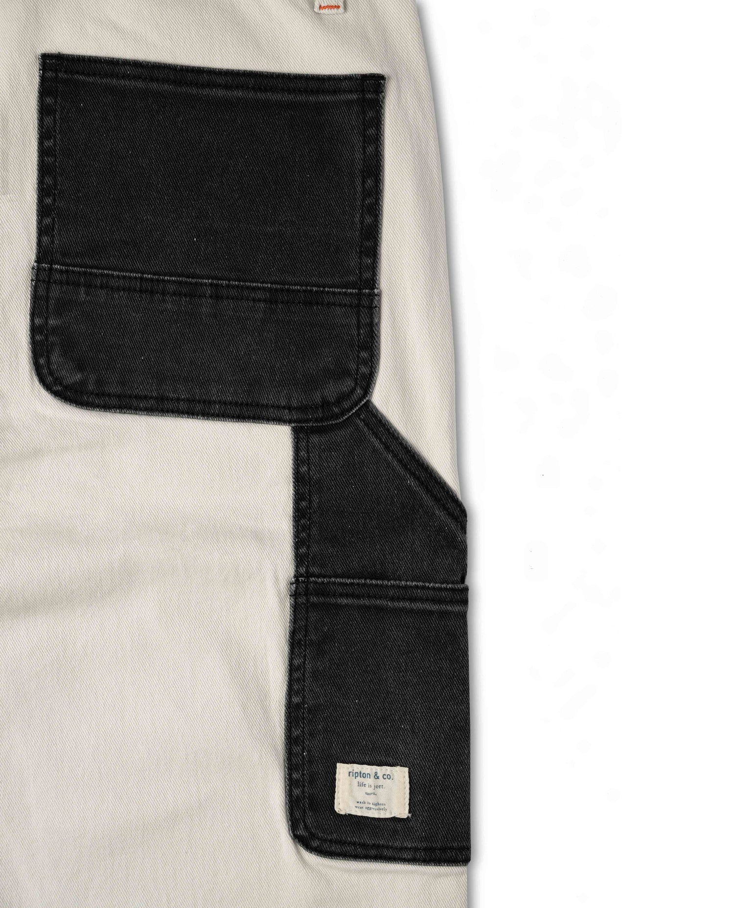 Close-up of a black and beige garment with a visible brand label.
