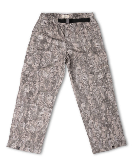 A pair of cargo pants featuring an abstract gray and beige camouflage pattern, shown flat on a white background with a black belt tucked inside the waistband.