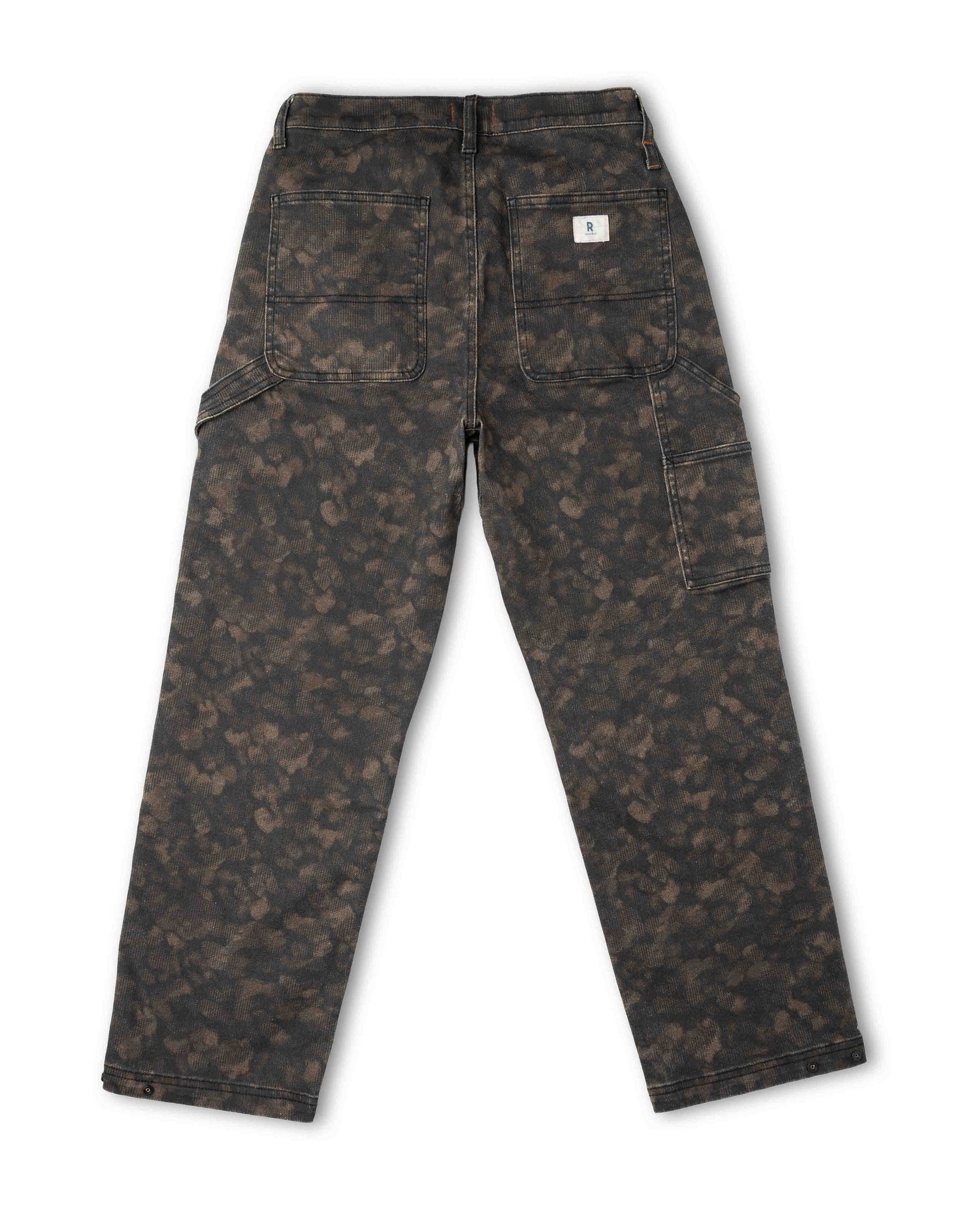A pair of Carhartt cargo pants in a dark brown and black camouflage pattern, shown from the back on a white background.