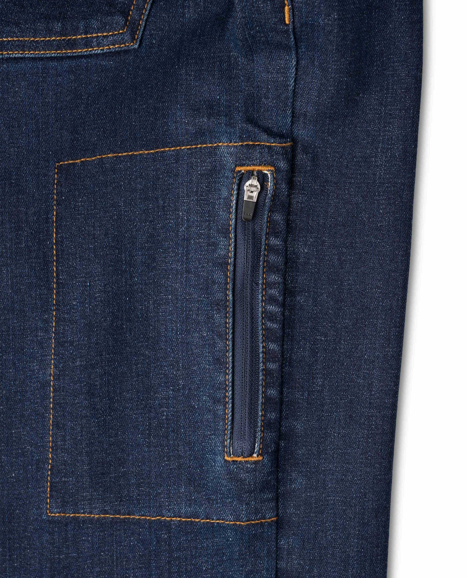 Zippered side pocket on dark wash jeans, on white background