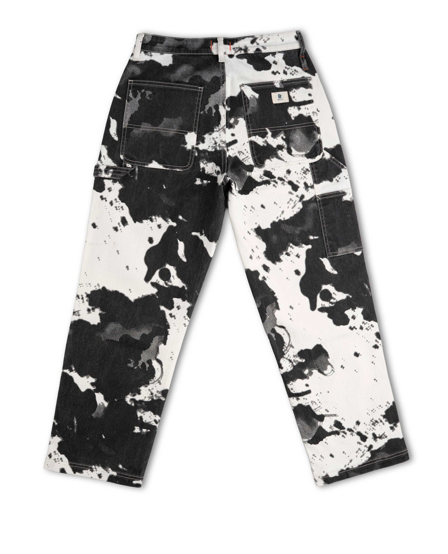 Black and white splatter paint pants on a white background