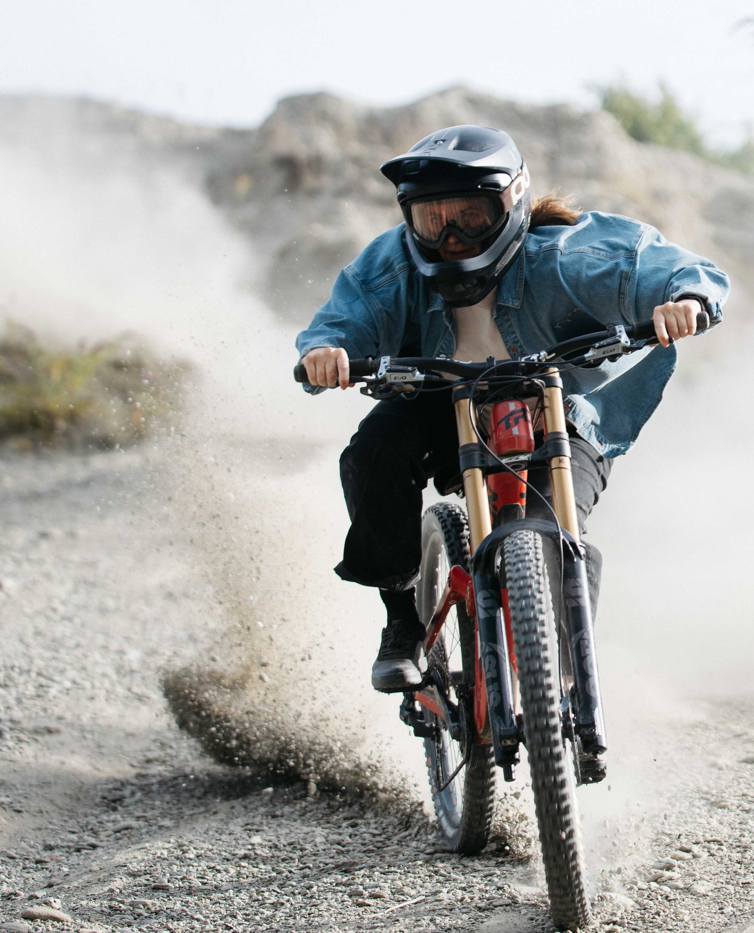 Person riding a mountain bike on a rocky trail