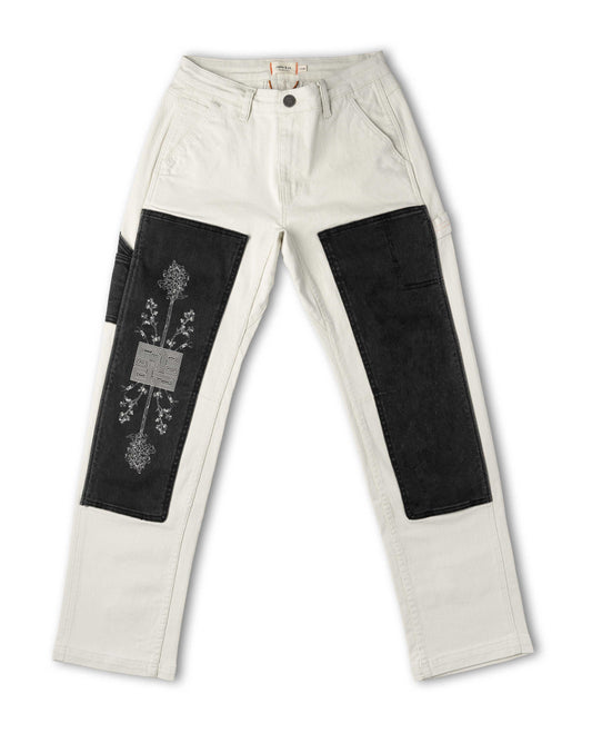 White pants with black patches on a white background