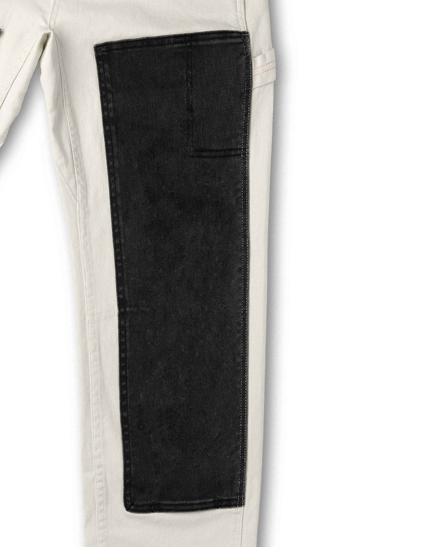 Close-up of a black pocket on a white pants background