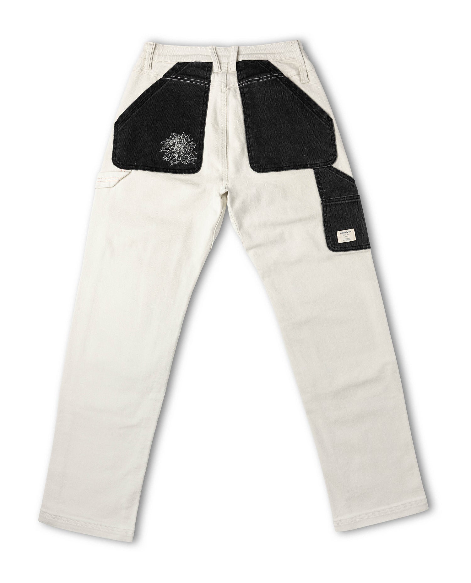 White pants with black patches on a white background