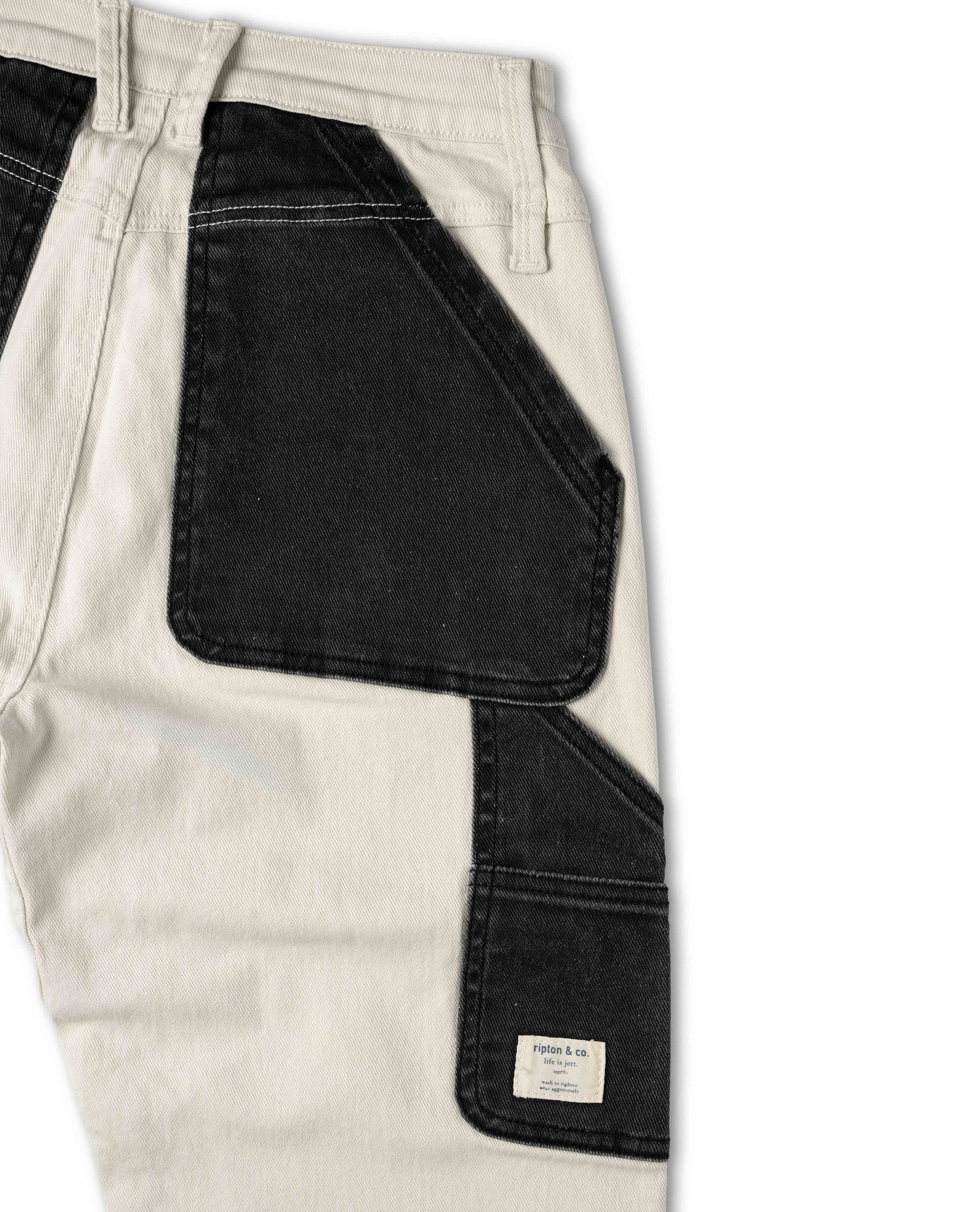 Close-up of a pants pocket with a brand label on a white background