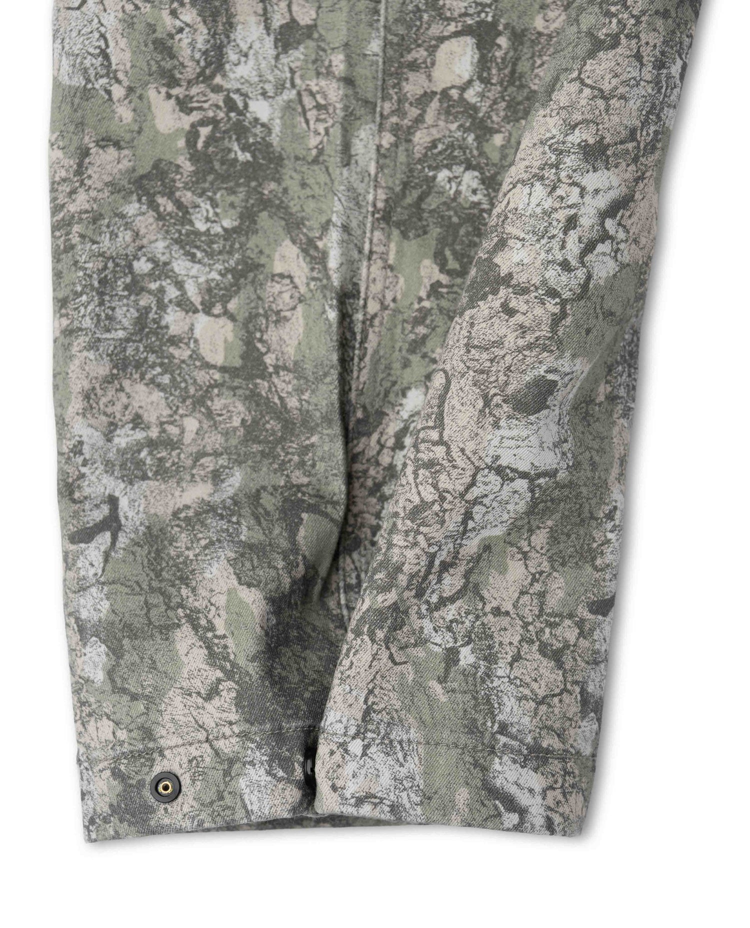Close-up of camouflage pants with a detailed pattern on a white background