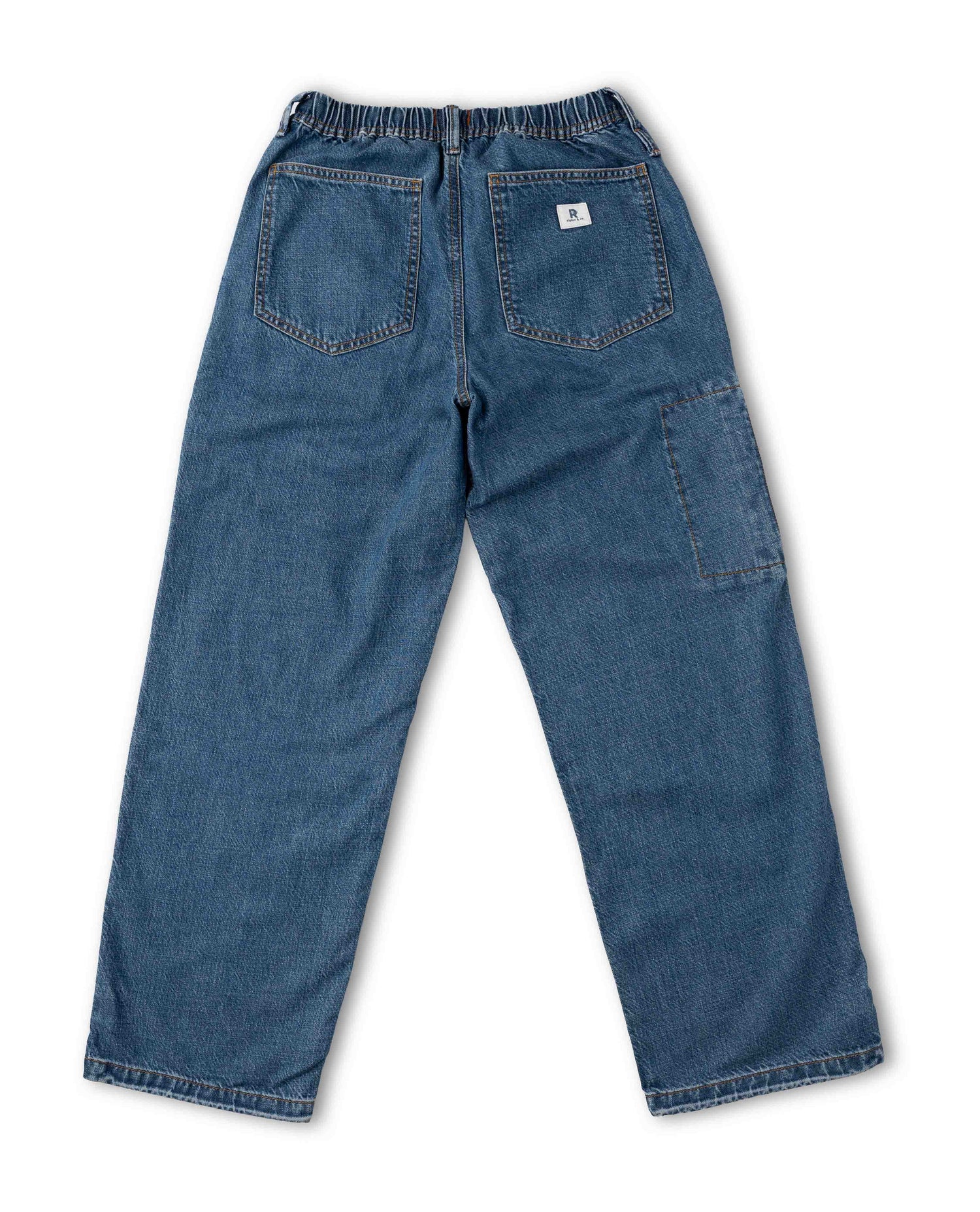 Blue denim work pants shown from the back, featuring an elastic waistband, two rear patch pockets, and a large side cargo pocket, photographed on a white background.